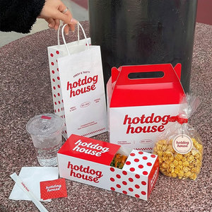 Cajas de cartón premium para hot dogs y corndogs, con diseño personalizado en rojo y blanco, fundas con puntos y bolsas de transporte con marca. - Product Image 2