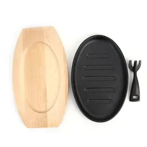 Venta caliente sartén de hierro fundido sartén plato de carne sartén de hierro fundido sartén plato caliente chisporroteante con base de madera