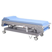 Table d'examen échographique électrique réglable en hauteur avec éponge haute densité, certifiée CE Classe II, et changement automatique des draps jetables