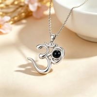 Colliers de projection personnalisés en cuivre plaqué or avec zircon 2026 Pendentif commémoratif personnalisé avec symbole OM pour unisexe