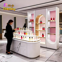 Vitrine de magasin de parfums et cosmétiques de luxe moderne haut de gamme en acier inoxydable avec éclairage LED, design écologique, dimensions personnalisables