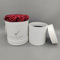 Rose éternelle blanche très vendue pour la Saint-Valentin dans un coffret cadeau rond en carton recyclé avec revêtement UV et logo personnalisé