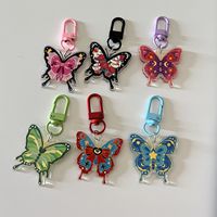 Vente en gros porte-clés personnalisé imprimé de luxe fermoir mousqueton perle papillon pendentif style dessin animé sac voiture acrylique porte-clés gland