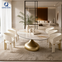 Table à manger ovale en pierre frittée avec base dorée trompette, ensemble de 6 chaises bouclées, luxe discret pour villa et hôtel, vente en gros, usine OEM