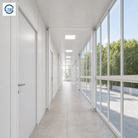Maison conteneur préfabriquée modulaire de bureau à deux étages avec mur-rideau entièrement vitré, fenêtre à auvent et porte double vitrée à cadre en acier