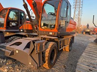 Mesin Pengolah Tanah Berkinerja Tinggi Kapasitas Bucket 0.86m³ Daya Terukur 127kW Excavator Roda DX210W untuk Proyek Konstruksi