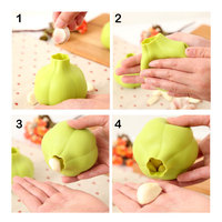 OEM & ODM 8.2*7.5cm Vente en gros Outil d'épluchage de cuisine créatif et utile Éplucheur d'ail en silicone à roulettes