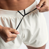 Vente en gros Short de cyclisme de jogging à séchage rapide 2 en 1 vierge Short d'entraînement de gymnastique en nylon et polyester avec poche pour téléphone