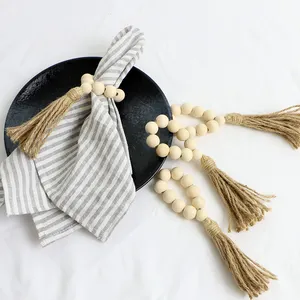 天然木珠餐桌艺术餐巾环套装，配有黄麻流苏，设计用于餐布架