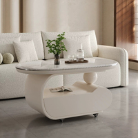 Table basse mobile incurvée en crème, surface en pierre microcristalline, base de rangement avec roulettes silencieuses, bureau minimaliste pour salon