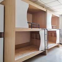 Lit superposé moderne multi-niveaux en forme de capsule, idéal pour les appartements étudiants, les hôtels-capsules et les auberges de jeunesse.