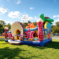 Parc d'attractions gonflable commercial avec toboggans, zones de saut et d'escalade, thème océan, pour enfants, aire de jeux gonflable