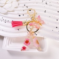 Vente en gros de porte-clés lettre époxy fleur pendentif résine cristal pendentif papillon gland porte-clés pour femmes sac portefeuille sac à main pendentif