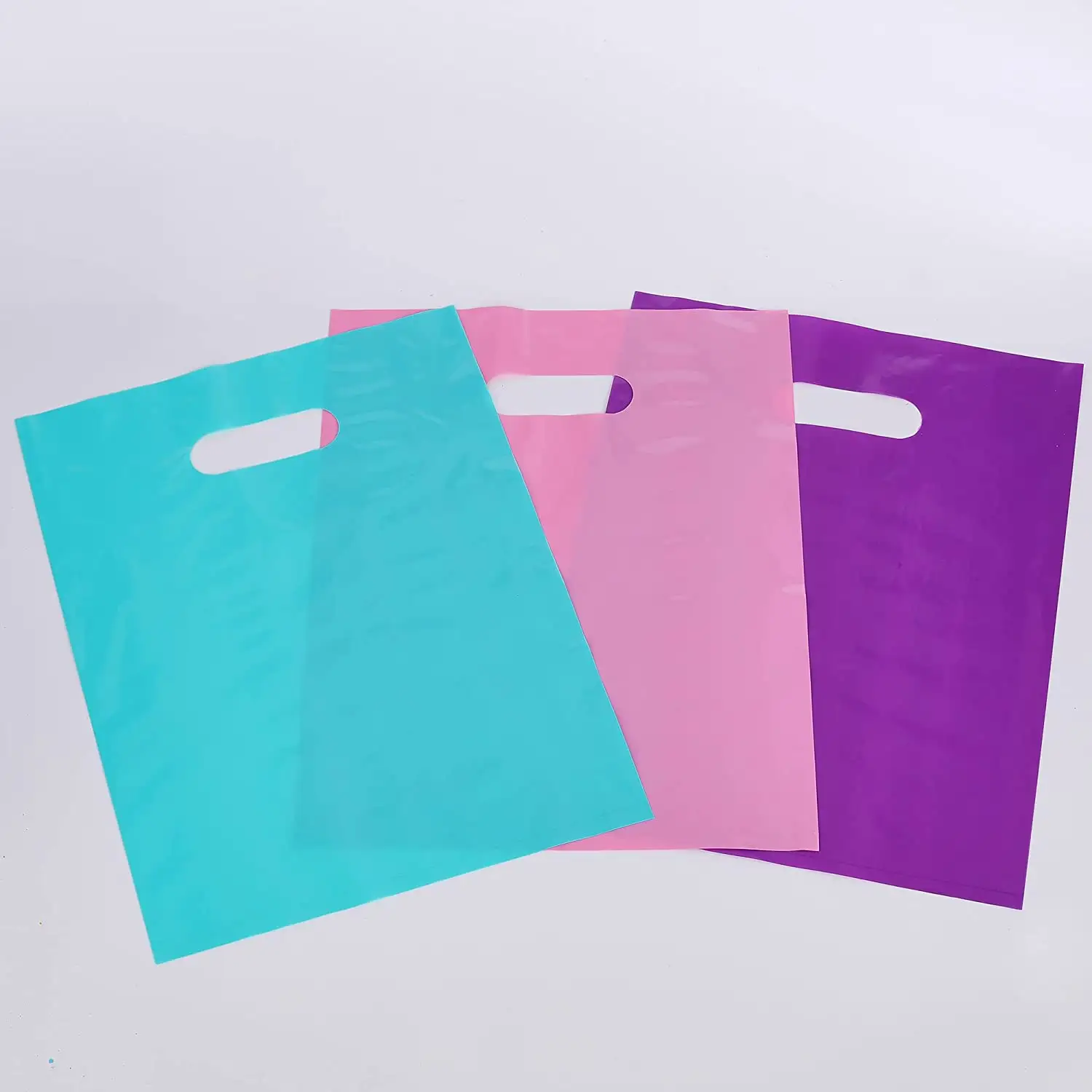 Sacs à provisions jetables en plastique de couleur unie au détail avec poignée découpée et sac à soufflet latéral d'impression par héliogravure pour usage professionnel