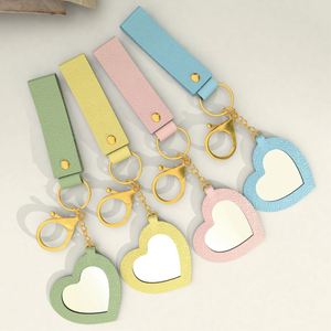 Low MOQ Cute and Creative Small PU <b>Leather</b> Heart-shaped Mirror <b>Keychain</b> with Many Colors for Bag Pendant in Stock - Product Image 1