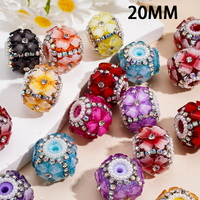 Strass en forme de cœur de couleur fluorescente, associés à un pendentif en métal argenté en forme de fleur et à une chaîne de perles demi-perles.