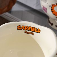 Article de collection : Tasse en céramique Garfield Family avec glaçure brillante et poignée colorée, idéale pour les fans.