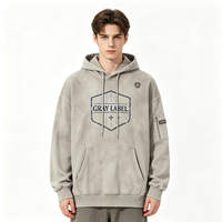 Sweat à capuche oversize avec cordon de serrage, imprimé vintage minimaliste, motif bouclier hexagonal Kornit DTG, poche latérale zippée, effet multi-déchiré, style streetwear