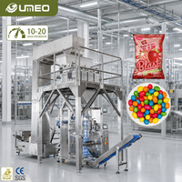 Machine d'emballage VFFS 50g-1500g avec peseuse à 4 têtes et trémie à motifs, automatique pour l'emballage de haricots, noix, snacks soufflés et granulés alimentaires