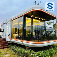 Maison-conteneur modulaire préfabriquée en métal respirant Capsule spatiale Immeuble de bureaux Hôtel Cabine pour camping Petite villa Maison