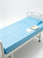 Draps médicaux jetables portables très demandés, matelas imperméable non tissé respirant avec trous pour une utilisation en milieu hospitalier