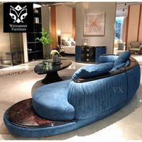 Canapé d'angle incurvé en cuir de luxe pour salon familial, canapé de salon bleu incurvé avec table basse