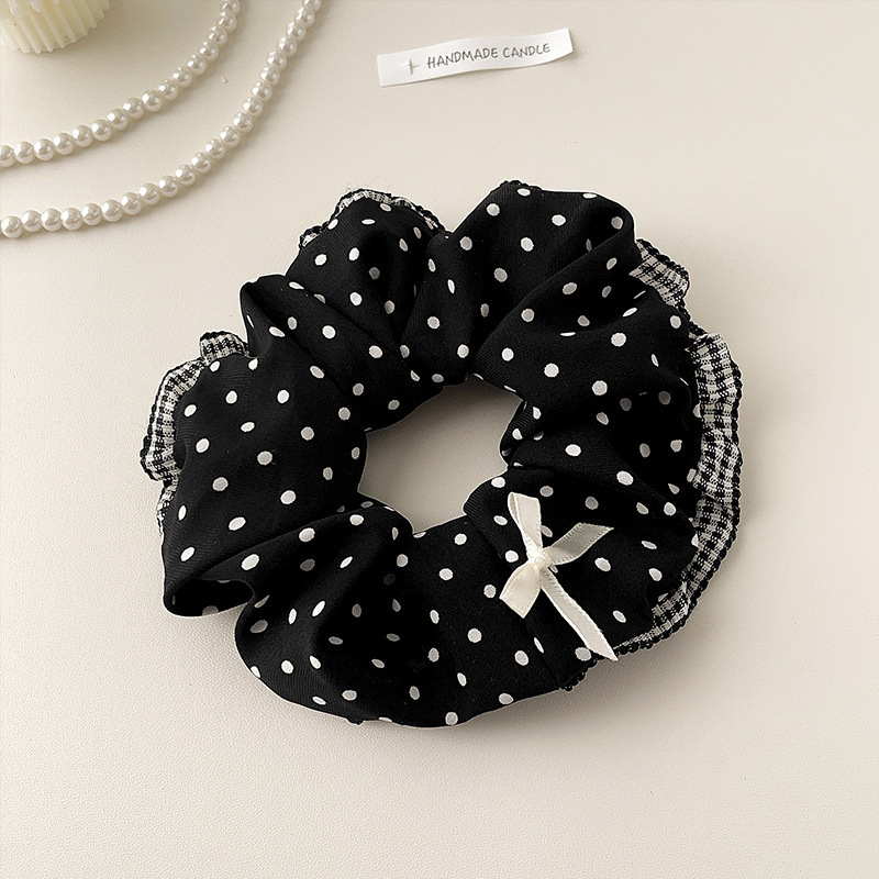Anneau de cheveux avec nœud à pois noirs