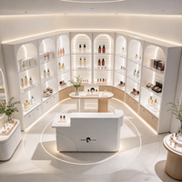 Kiosque de présentation cosmétique blanc en arc, unités d'affichage ouvertes, comptoir central, rangement verrouillable, bande LED, CE ETL pour salon de beauté