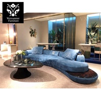 Canapé d'angle incurvé en cuir de luxe pour salon familial, canapé de salon bleu incurvé avec table basse