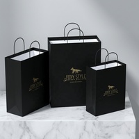 Sac en papier d'art de luxe de marque avec pelliculage mat et logo doré pour vêtements de mode haut de gamme