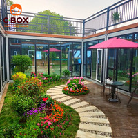 Cbox Maison conteneur modulaire préfabriquée à deux étages avec mur-rideau en verre, bureau, balcon et escalier