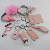 Ensemble de porte-clés de sécurité promotionnels en gros Alarme personnelle Pom Pom Ball Bracelet en silicone DIY 11PCS Ensemble de porte-clés d'autodéfense