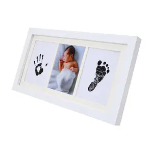 A commemorative gift set made of solid wood material with ink frame for baby's hands and feet for newborn mothers