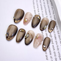 Vente en gros de faux ongles réutilisables faits à la main, motif œil de chat marron, avec accents de strass et de perles dorées, en vrac