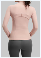 Veste de yoga zippée intégrale pour femme, manches longues, col montant, poches latérales zippées, passe-pouces, coupe ajustée, coutures discrètes, haut de sport pour la course et l'entraînement en salle de sport
