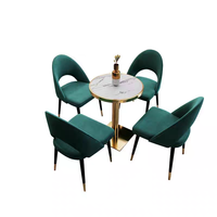 Ensemble de table et de chaises de restaurant de luxe moderne avec velours vert, marbre et acier inoxydable pour utilisation dans les cafés