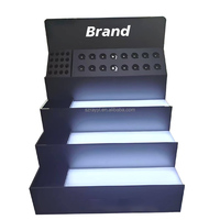 Présentoir personnalisé de luxe RAY YI pour parfums en acrylique noir mat à 4 couches/présentoir d'ombres à paupières en plexi pour pinceaux de maquillage