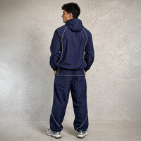Ensemble de survêtement personnalisé en nylon respirant coupe-vent unisexe avec fermeture éclair, veste de sport brodée à capuche et pantalon pour homme