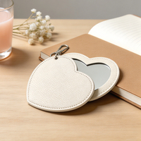 Miroir de voyage rotatif portable en cuir PU en forme de cœur, logo personnalisé, cosmétique, mini miroir personnalisé, porte-clés pour cadeaux