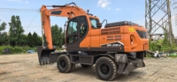 Mesin Pengolah Tanah Efisiensi Tinggi Kapasitas Bucket 0.86m³ Daya Terukur 127kW Excavator Roda DX210W untuk Teknik Kehargaan Kota