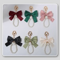 Porte-clés en ruban perlé avec breloque nœud en cristal pour femme et fille, accessoire de mode en tissu de soie, pendentif pour sac