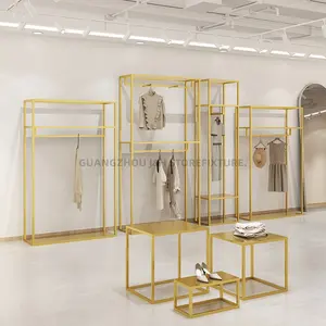 Étagère à vêtements de luxe pour boutique de vêtements pour femmes présentoir à vêtements en or pour magasin de détail