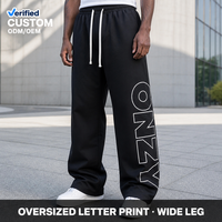 Pantalon de survêtement ample à rayures latérales contrastées en nylon technique résistant à l'eau, avec grand motif, pour tenue streetwear urbaine