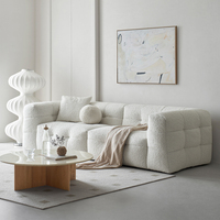 Canapé confortable en tissu bouclé au design rétro français 2025, idéal pour le salon ou la chambre d'étudiant