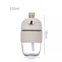 Bouteille d'eau isotherme tendance en verre portable pour femme, grande capacité, avec couvercle à paille, motif lapin de dessin animé mignon, résistante à la chaleur, vente en gros