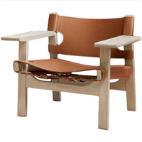 Fauteuils de salon en cuir véritable et bois massif, design vintage de haute qualité, confortables et modernes, conçus par des designers excellents.