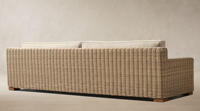 Canapé d'extérieur en osier élégant, résistant aux intempéries, avec cadre tressé à la main et coussins beiges, mobilier de salon modulaire pour jardin