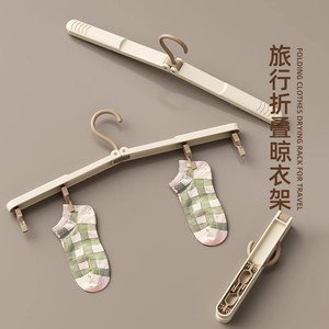 Folding <b>clothes</b> hanger, travel-grade, residue-free <b>clothes</b> <b>rack</b> with clips, portable for travel, business trips, and hotels. A m - Product Image 1