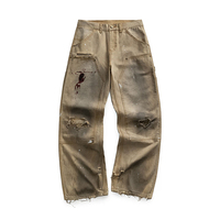 Jeans pour hommes de marques tendance avec finitions usées et salies, motifs peints à l'encre mélangée, style cabane, pantalons droits à jambes larges