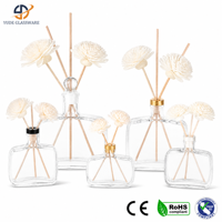 Bouteille diffuseur en verre transparent avec arrangement élégant de bâtonnets pour le parfum des comptoirs de réception et des zones d'accueil